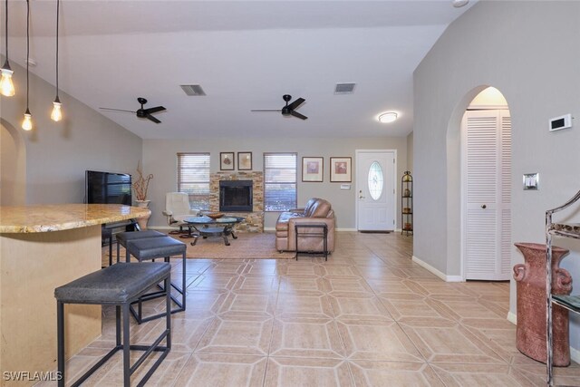 living room with ceiling fan, a wealth of natural light, and light tile patterned floors