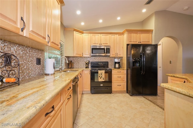 kitchen featuring black appliances, light brown cabinetry, tasteful backsplash, sink, and vaulted ceiling