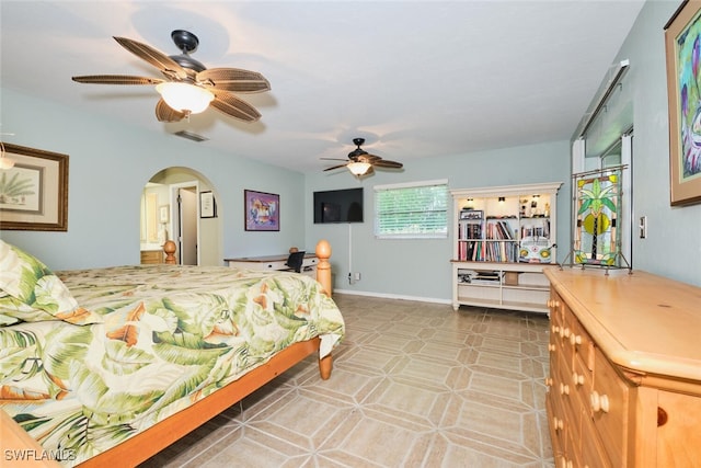 tiled bedroom featuring ceiling fan