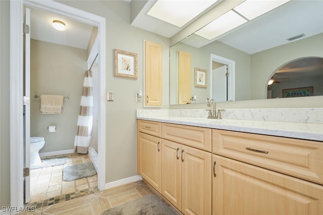 bathroom featuring tile patterned floors, toilet, vanity, and ceiling fan