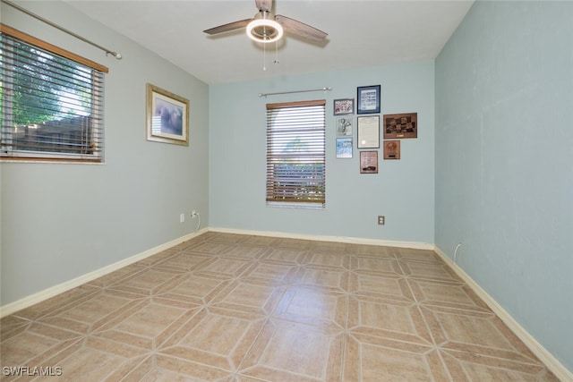 tiled empty room featuring ceiling fan