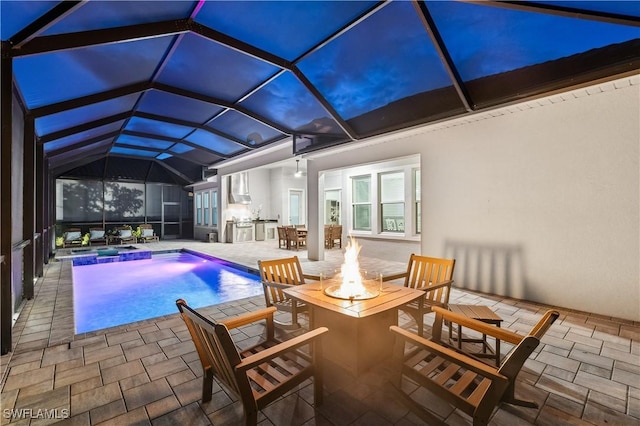 view of pool featuring a patio, glass enclosure, and area for grilling