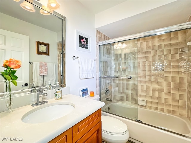 full bathroom featuring enclosed tub / shower combo, toilet, and vanity