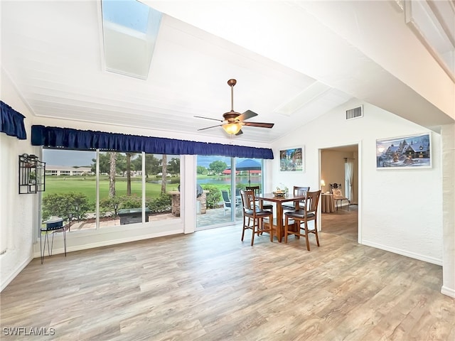 interior space with lofted ceiling with skylight and ceiling fan