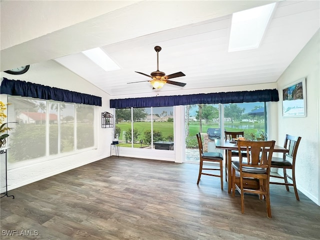 sunroom / solarium with ceiling fan and vaulted ceiling with skylight