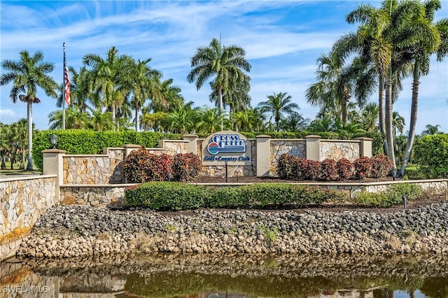 community / neighborhood sign featuring a water view