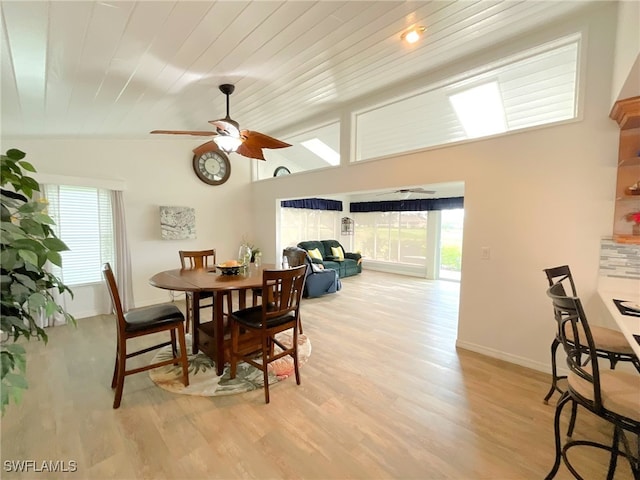 dining area featuring a wealth of natural light, ceiling fan, and light hardwood / wood-style flooring