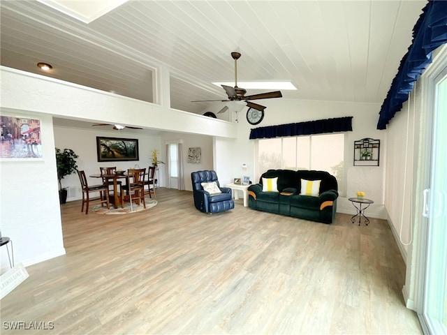 living room with hardwood / wood-style flooring, ceiling fan, plenty of natural light, and vaulted ceiling