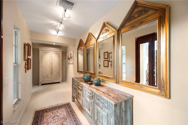 1303 Wahoo Ct, Naples, FL 34102 - hall with rail lighting and light tile patterned flooring
