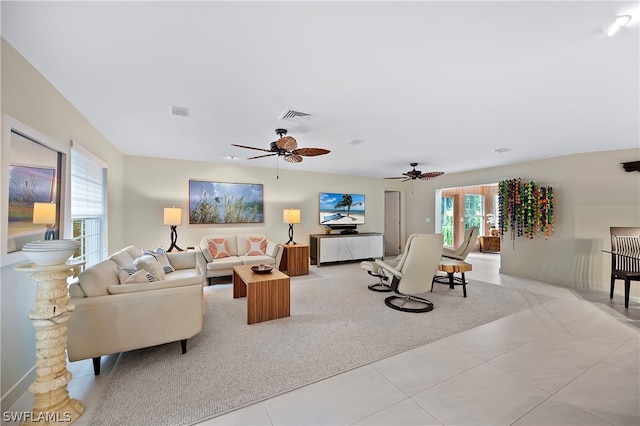 1303 Wahoo Ct, Naples, FL 34102 - living area with light tile patterned floors and ceiling fan