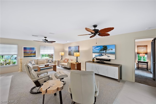 living room with light tile patterned floors and ceiling fan