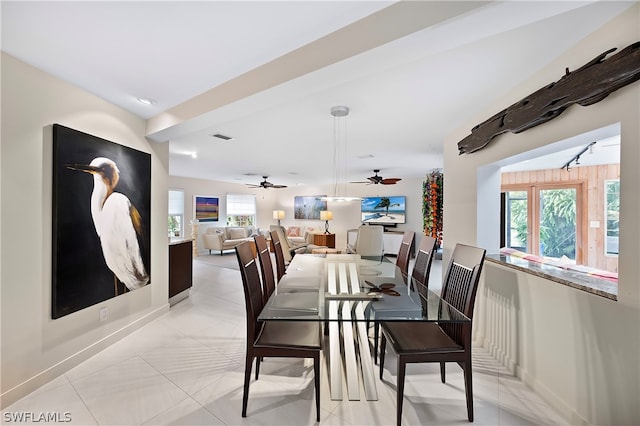 dining space with ceiling fan, light tile patterned floors, and rail lighting