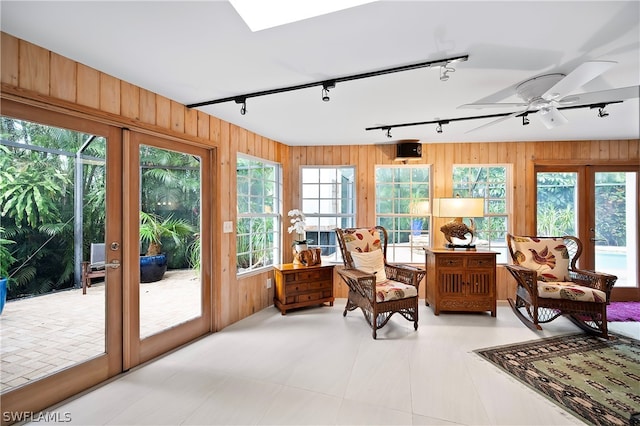 sunroom featuring ceiling fan, french doors, and rail lighting