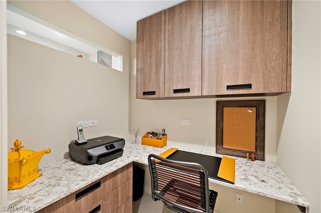 1303 Wahoo Ct, Naples, FL 34102 - kitchen featuring built in study area, modern cabinets, and brown cabinets