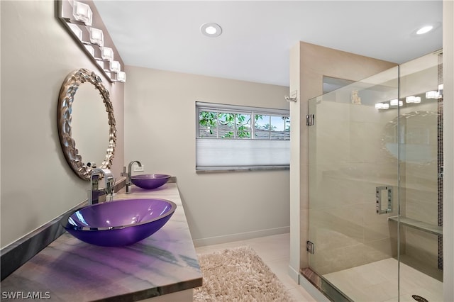 1303 Wahoo Ct, Naples, FL 34102 - full bath featuring a shower stall, double vanity, recessed lighting, and tile patterned floors