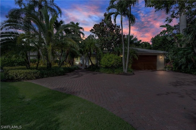 1303 Wahoo Ct, Naples, FL 34102 - view of front of house featuring driveway, a garage, and a lawn