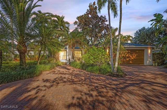 1303 Wahoo Ct, Naples, FL 34102 - view of front of property featuring a garage and decorative driveway