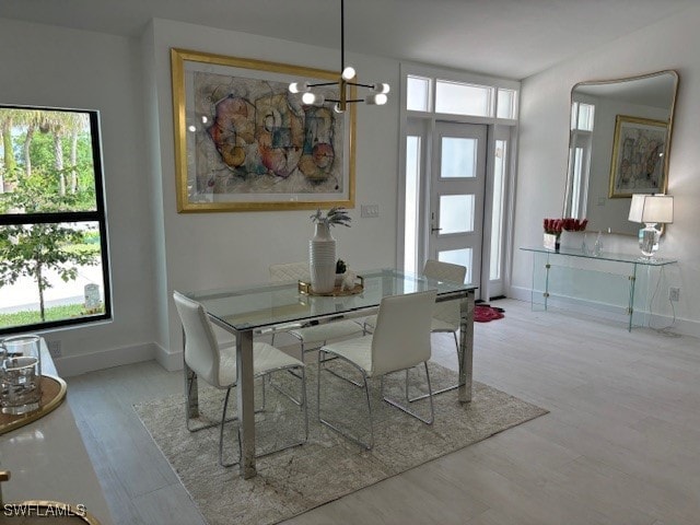 dining space with an inviting chandelier and hardwood / wood-style flooring