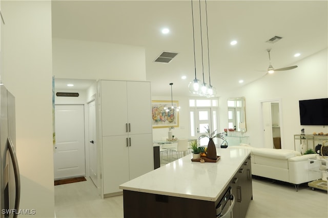 kitchen with a center island, ceiling fan, light tile patterned flooring, and hanging light fixtures