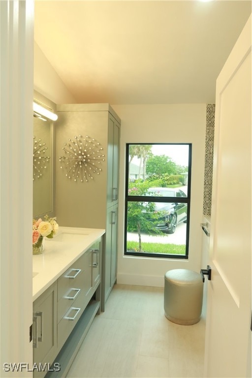 bathroom featuring vanity, tile patterned flooring, and a healthy amount of sunlight