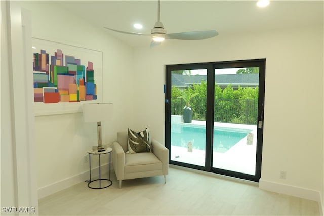 sitting room featuring ceiling fan and vaulted ceiling