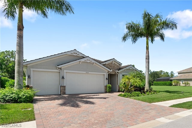 view of front of property with a garage and a front yard