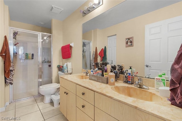 bathroom featuring an enclosed shower, vanity, tile patterned flooring, and toilet