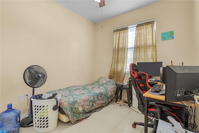 bedroom with ceiling fan, light tile patterned floors, and multiple windows