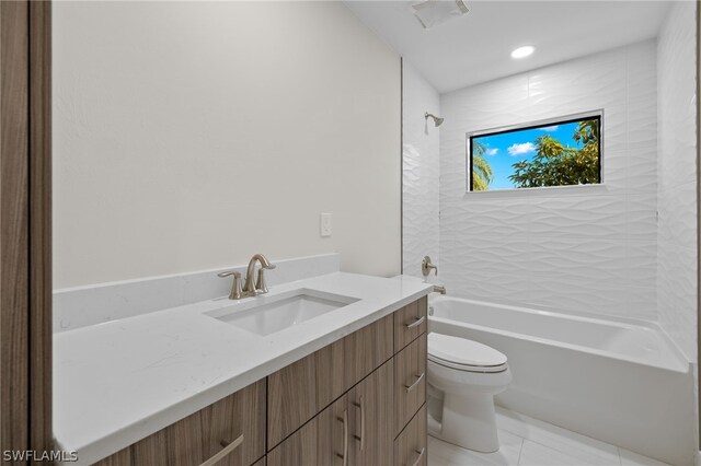 full bathroom featuring vanity, tiled shower / bath, and toilet