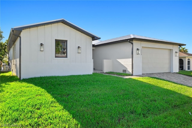 12230 Matlacha Blvd, Matlacha Isles, FL 33991 - single story home with board and batten siding, a front lawn, a garage, and driveway