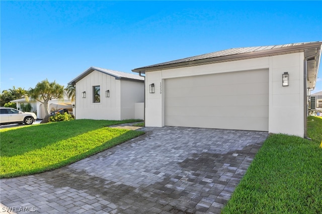 ranch-style house with a garage and a front yard