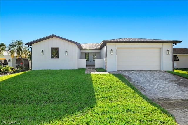 view of front facade with a garage and a front lawn