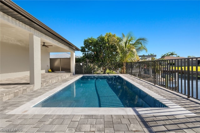 view of pool with a patio and ceiling fan