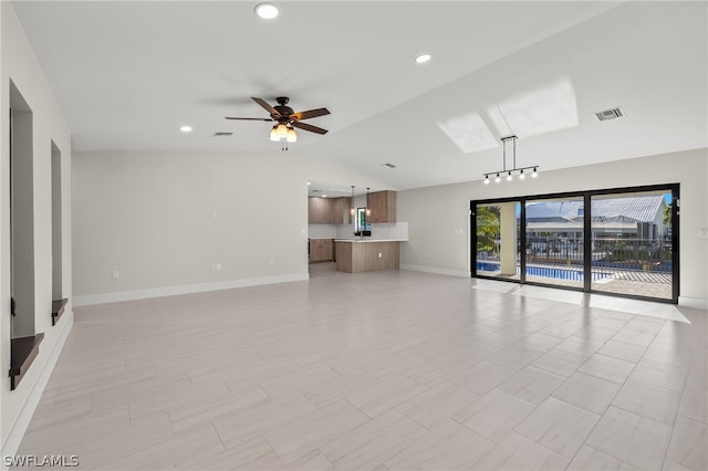 unfurnished living room with lofted ceiling and ceiling fan