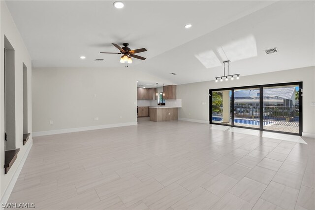 12230 Matlacha Blvd, Matlacha Isles, FL 33991 - unfurnished living room featuring lofted ceiling, a ceiling fan, baseboards, and recessed lighting