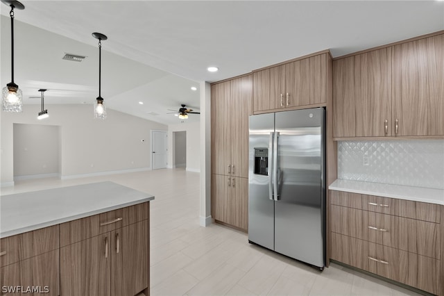 kitchen with decorative light fixtures, tasteful backsplash, lofted ceiling, ceiling fan, and stainless steel fridge with ice dispenser