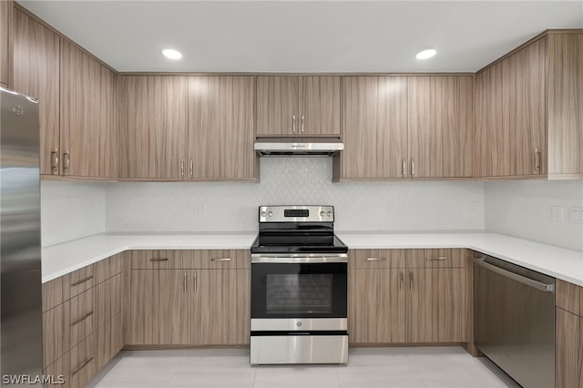 kitchen with light tile patterned floors, decorative backsplash, and appliances with stainless steel finishes