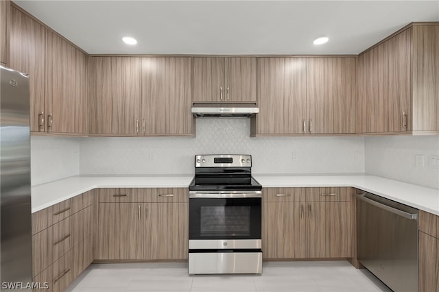 12230 Matlacha Blvd, Matlacha Isles, FL 33991 - kitchen with stainless steel appliances, under cabinet range hood, light countertops, tasteful backsplash, and recessed lighting