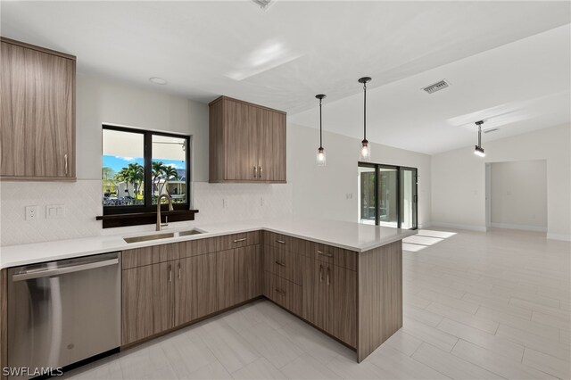 12230 Matlacha Blvd, Matlacha Isles, FL 33991 - kitchen with stainless steel dishwasher, a sink, a peninsula, decorative backsplash, and light countertops