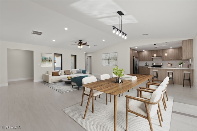 dining space featuring vaulted ceiling and ceiling fan