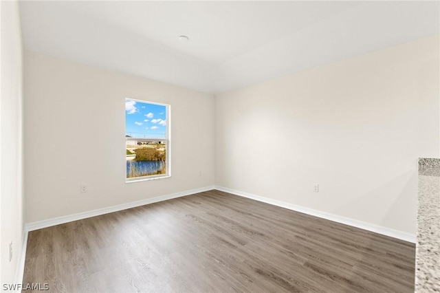 unfurnished room with hardwood / wood-style flooring