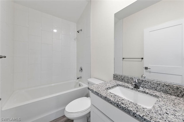 full bathroom with toilet, hardwood / wood-style floors, vanity, and shower / bathing tub combination