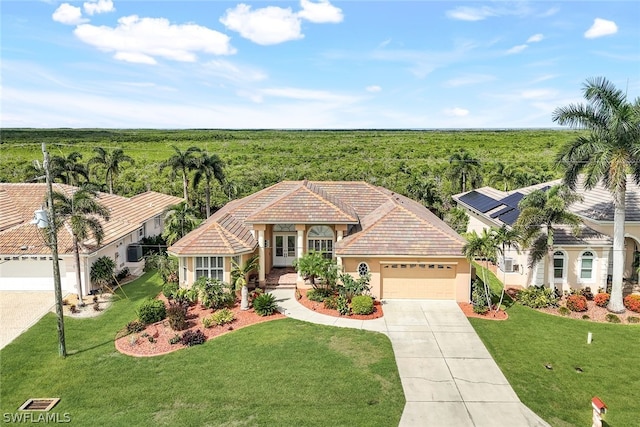 view of front of home with a garage, a front lawn, and solar panels