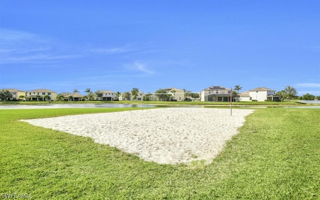 view of property's community featuring a lawn and volleyball court