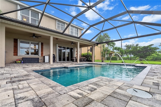 view of pool featuring a lanai, a patio, pool water feature, and ceiling fan