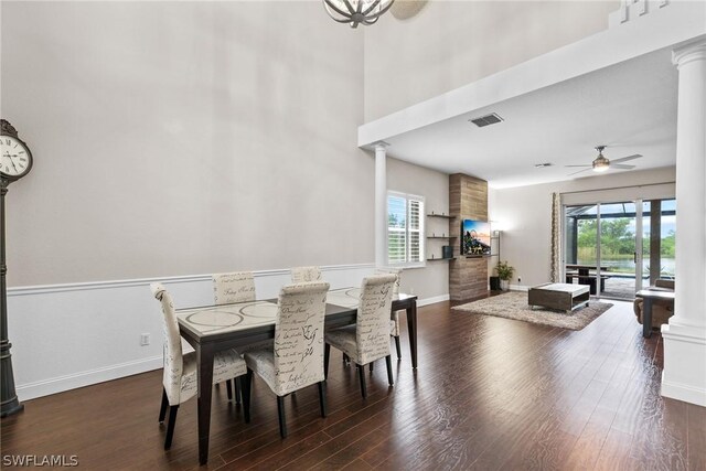 dining area featuring dark hardwood / wood-style flooring, ornate columns, and ceiling fan