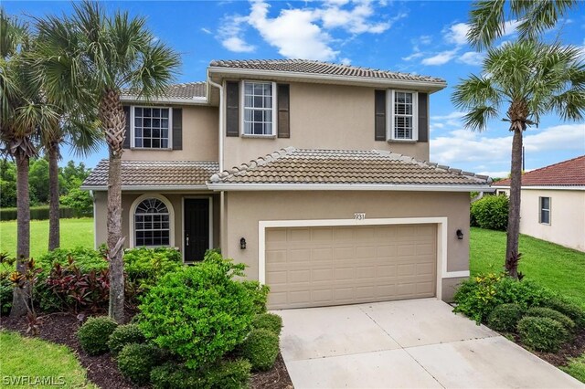 mediterranean / spanish-style house with a garage and a front yard