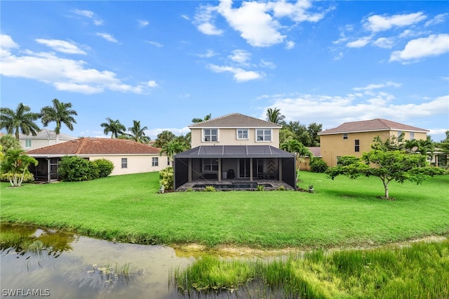 rear view of property with a yard and glass enclosure