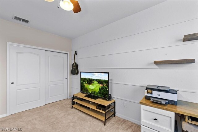 office area featuring light carpet and ceiling fan