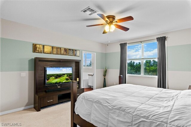 carpeted bedroom with multiple windows and ceiling fan